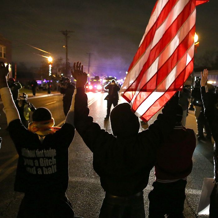FERGUSON, MO - NOVEMBER 24: Protestors stand with their hands up during a demonstration on November 24, 2014 in Ferguson, Missouri. A St. Louis County grand jury has decided to not indict Ferguson police Officer Darren Wilson in the shooting of Michael Brown that sparked riots in Ferguson, Missouri in August. (Photo by Justin Sullivan/Getty Images)
