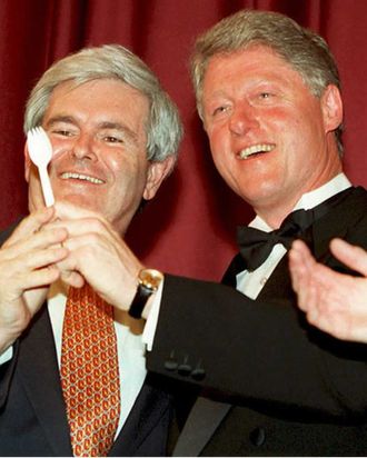 Before the annual dinner of the Radio and Television Correspondents Association in Washington 14 March 1995, US President Bill Clinton (R) poses with House Speaker Newt Gingrich as President Clinton shows Gingrich a plastic utensil known as a