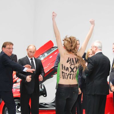 Bare-breasted woman protest against Vladimir Putin at a trade fair in Germany. The anti-Putin activist seem to be part of feminist group Femen.