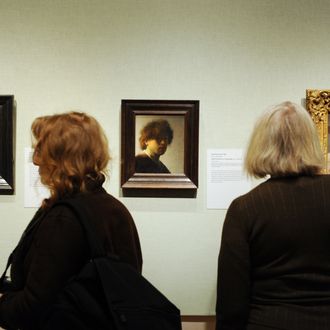 People view self-portraits by Rembrandt van Rijn (L and C) and Edgar Degas (R) in the exhibition, 