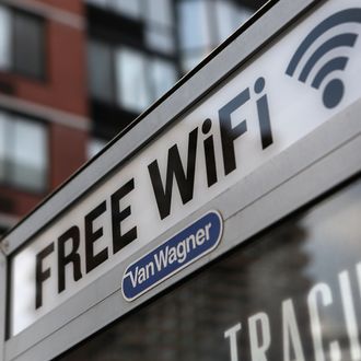 NEW YORK, NY - JULY 11: A free Wi-Fi hotspot beams broadband internet from atop a public phone booth on July 11, 2012 in Manhattan, New York City. New York City launched a pilot program Wednesday to provide free public Wi-Fi at public phone booths around the five boroughs. The first ten booths were lit up with Wi-Fi routers attached to the top of existing phone booths, with six booths in Manhattan, two in Brooklyn, and one in Queens. Additional locations, including ones in the Bronx and Staten Island, are to be added soon. (Photo by John Moore/Getty Images)