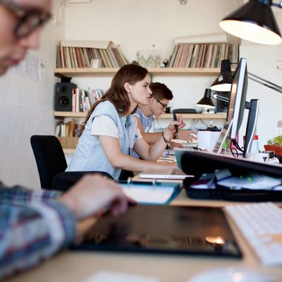 Young group of people working in creative loft design office