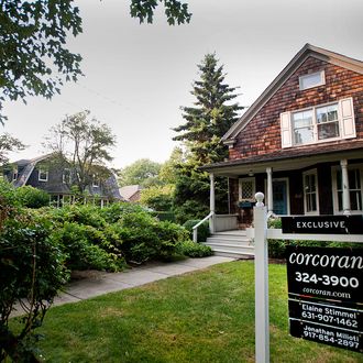 A Corcoran Group Inc. for sale sign hangs in the yard of a home in East Hampton, New York, U.S. on Wednesday, July 20, 2011. Home prices in New York's Hamptons, the Long Island resort towns favored by summering Manhattanites, increased 4.2 percent in the second quarter from a year earlier as buyers opted for more expensive beach properties. Photographer: Paul Taggart/Bloomberg via Getty Images