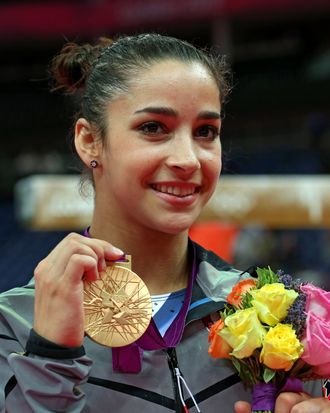 Gold medalist Alexandra Raisman of the United States poses on the podium during the medal ceremony for the Artistic Gymnastics Women's Floor Exercise final on Day 11 of the London 2012 Olympic Games at North Greenwich Arena on August 7, 2012 in London, England. 