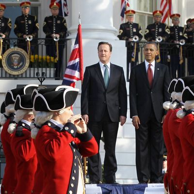 U.S. President Barack Obama (R) and British Prime Minister David Cameron review the U.S. Army's Old Guard Fife and Drum Corps during an official arrival ceremony on the South Lawn of the White House March 14, 2012 .