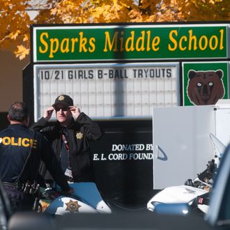 SPARKS, NV - OCTOBER 21: Law enforcement gather in the parking lot after a shooting at Sparks Middle School October 21, 2013 in Sparks, Nevada. A staff member was killed and two students were injured after a student opened fire at the Nevada middle school. The suspected gunman was also killed. (Photo by David Calvert/Getty Images)
