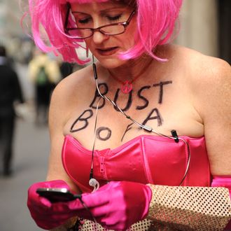 Jodie Evans wears a message on her chest as she protests Bank of America policies, part of International Women’s Day demonstrations March 8, 2012 outside the Waldorf Astoria Hotel in New York. The Citi Finanical Services Conference was meeting inside the hotel and was featuring Bank of America CEO Brian Moynihan via teleconference. AFP PHOTO/Stan HONDA (Photo credit should read STAN HONDA/AFP/Getty Images)