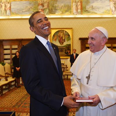 Pope Francis (2ndR) and US President Barack Obama exchange gifts during a private audience on March 27, 2014 at the Vatican. The meeting at the Vatican comes as a welcome rest-stop for Obama during a six-day European tour dominated by the crisis over Crimea, and the US leader will doubtless be hoping some of the pope's overwhelming popularity will rub off on him. 