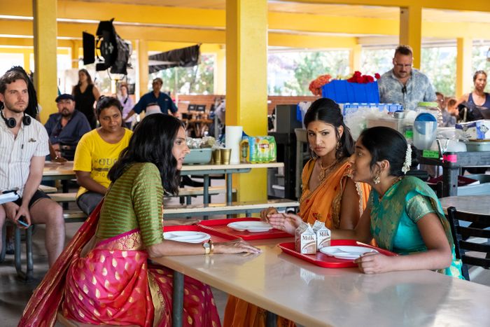 Mindy Kaling watches a scene with Maitreyi Ramakrishnan (right), Richa Moorjani (center), and Poorna Jagannathan (left).