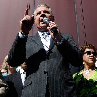 Seattle Mayor Ed Murray, left, stands with supporters of Seattle's $15 minimum wage law as he speaks Monday, June 2, 2014, at a rally outside Seattle City Hall after the Seattle City Council passed the $15 minimum wage measure in a meeting.