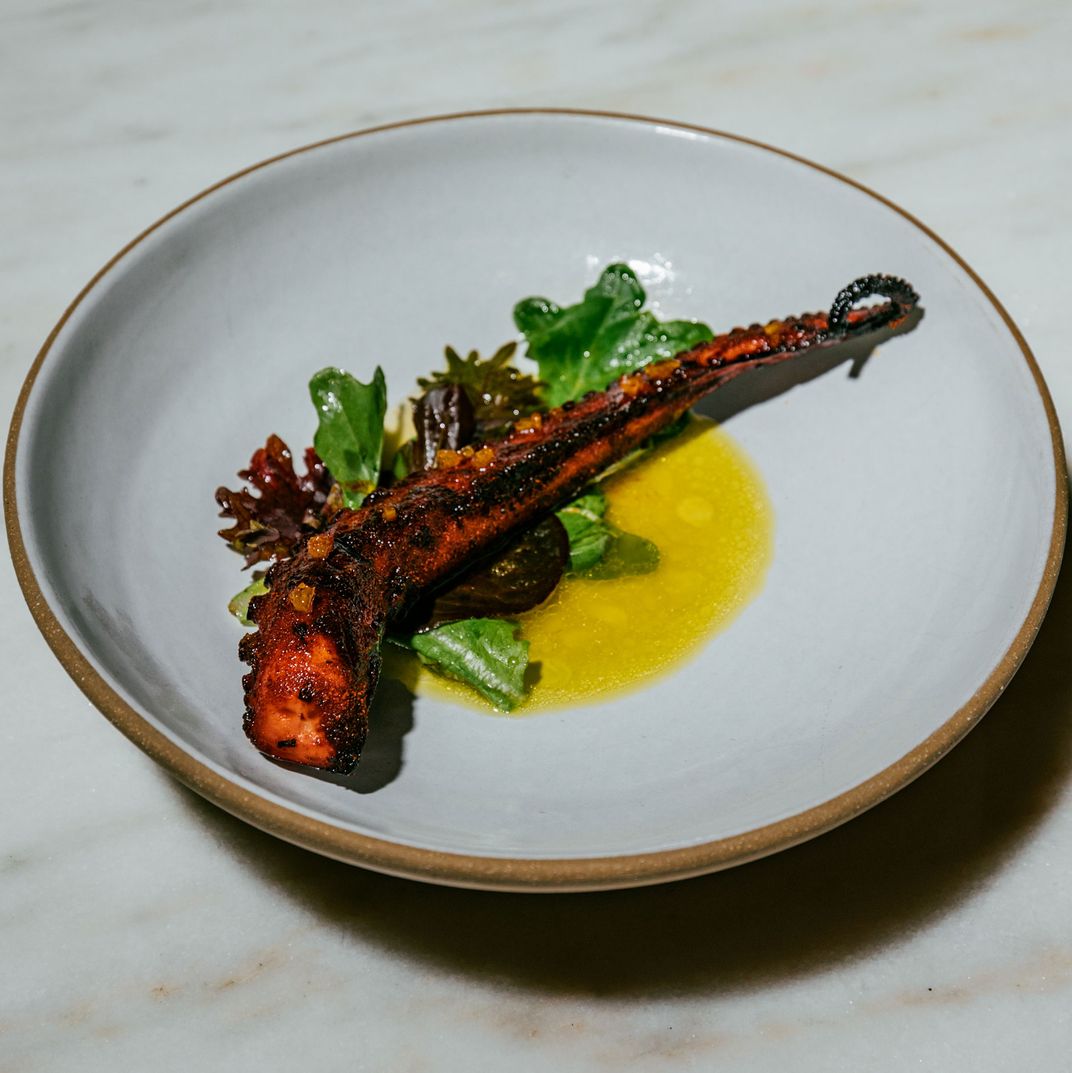 Grilled octopus with candied kumquats and Antep chili crunch.