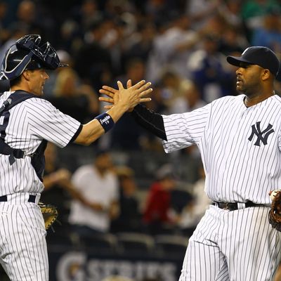 CC Sabathia #52 of the New York Yankees celebrates his complete game 6-2 victory against the Atlanta Braves with Chris Stewart #19 after their game on June 18, 2012 at Yankee Stadium in the Bronx borough of New York City. 