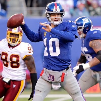 New York Giants Eli Manning gets set to throw a pass in the third quarter against the Washington Redskins in week 15 of the NFL season at MetLife Stadium in East Rutherford, New Jersey on December 18, 2011