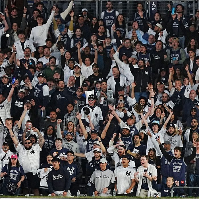 New York Yankees fans celebrate a home run at Yankee Stadium.