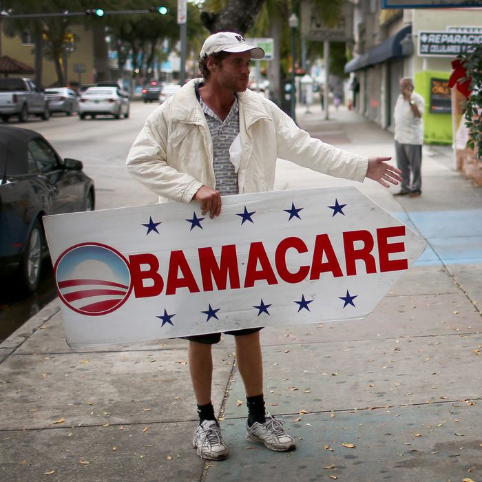 Pedro Rojas holds a sign directing people to an insurance company where they can sign up for the Affordable Care Act, also known as Obamacare, before the February 15th deadline on February 5, 2015 in Miami, Florida. 
