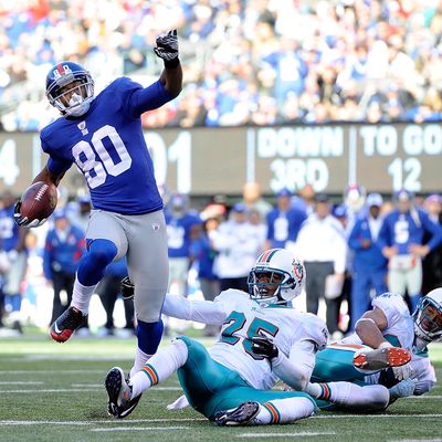 EAST RUTHERFORD, NJ - OCTOBER 30: Victor Cruz #80 of the New York Giants leaps over Will Allen #25 of the Miami Dolphins on his way to scoring a 25 yard touchdown in the fourth quarter against the Miami Dolphins at MetLife Stadium on October 30, 2011 in East Rutherford, New Jersey. (Photo by Patrick McDermott/Getty Images)