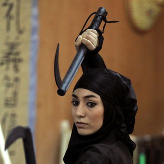 An Iranian female Ninja demonstrates her Ninjutsu skills in a martial arts club during a showcase for the media in the city of Karaj, 40 kms west of the capital Tehran, on March 15, 2012.