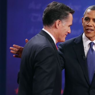 Democratic presidential candidate, U.S. President Barack Obama (R) pats Republican presidential candidate, former Massachusetts Gov. Mitt Romney on the back after the Presidential Debate at the University of Denver on October 3, 2012 in Denver, Colorado. The first of four debates for the 2012 Election, three Presidential and one Vice Presidential, is moderated by PBS's Jim Lehrer and focuses on domestic issues: the economy, health care, and the role of government. 
