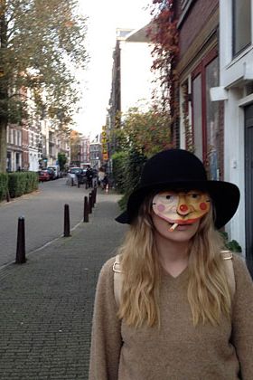 Andrea poses in her Halloween mask on the street in Amsterdam.