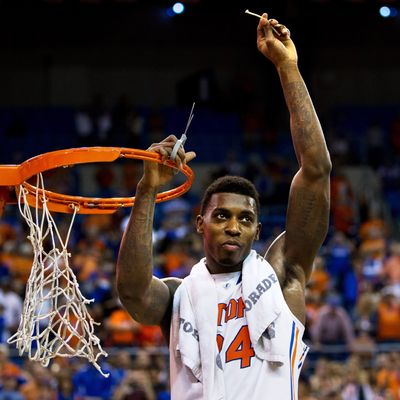 Casey Prather #24 of the Florida Gators holds up a piece of the net after the game against the Kentucky Wildcats at the Stephen C. O'Connell Center on March 8, 2014 in Gainesville, Florida. The Gators were 18-0 in the SEC Conference and undefeated at home this season. 