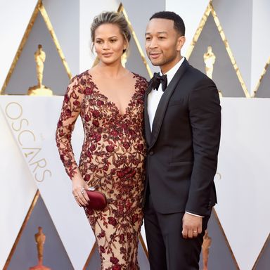 Chrissy Teigen and John Legend 
Dress by Marchesa; jewels by Lorraine Schwartz; clutch by Swarovski; watch by Bulgari (on Legend).