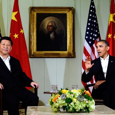 US President Barack Obama (R) answers a question as Chinese President Xi Jinping listens following their bilateral meeting at the Annenberg Retreat at Sunnylands in Rancho Mirage, California, on June 7, 2013.Obama, with Chinese counterpart Xi Jinping by his side, called Friday for common rules on cybersecurity after allegations of hacking by Beijing. At a summit in the Calfornia desert, Obama said it was 