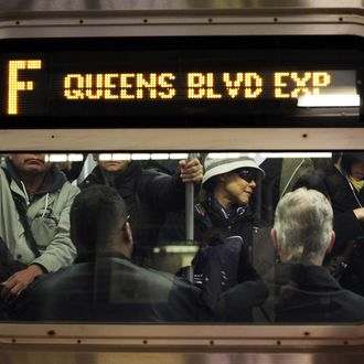 Commuters ride the F train 