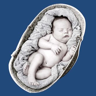 Baby sleeping snugly in moses basket