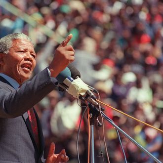 Anti-apartheid leader and African National Congress (ANC) member Nelson Mandela addresses at a funeral of 12 people died during recent township unrests in Soweto, 20 September 1990, in Soweto. (Photo credit should read ALEXANDER JOE/AFP/Getty Images)