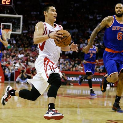 Jeremy Lin #7 of the Houston Rockets drives upcourt past Tyson Chandler #6 the New York Knicks at the Toyota Center on November 23, 2012 in Houston, Texas.