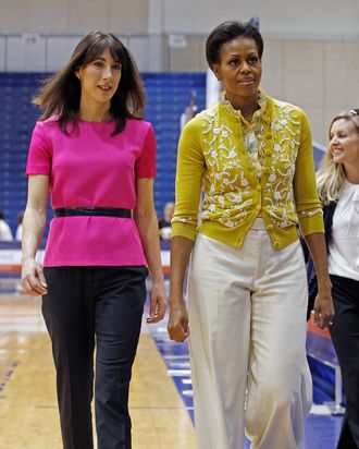 First lady Michelle Obama (L) and Samantha Cameron, wife of British Prime Minister David Cameron, participate in an Olympics-themed event with area school children at American University March 13, 2012 in Washington, DC. Fifth graders from MacFarland Middle School in Washington, D.C., Manor View Elementary School in Maryland and Arlington Science Focus School in Virginia participated in a mini-Olympics competition in celebration of the 2012 London Summer Olympics and Mrs. Obama's Let's Move! initiative.