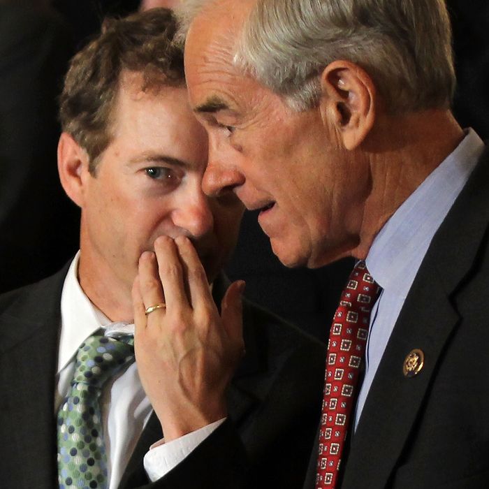 U.S. Sen. Rand Paul (R-KY) (L) talks to his father Rep. Ron Paul (R-TX) (R) during a news conference June 22, 2011 on Capitol Hill in Washington, DC. A number of Republican congressional members joined The Cut, Cap, Balance Pledge Coalition at the news conference 