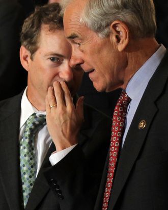 U.S. Sen. Rand Paul (R-KY) (L) talks to his father Rep. Ron Paul (R-TX) (R) during a news conference June 22, 2011 on Capitol Hill in Washington, DC. A number of Republican congressional members joined The Cut, Cap, Balance Pledge Coalition at the news conference 