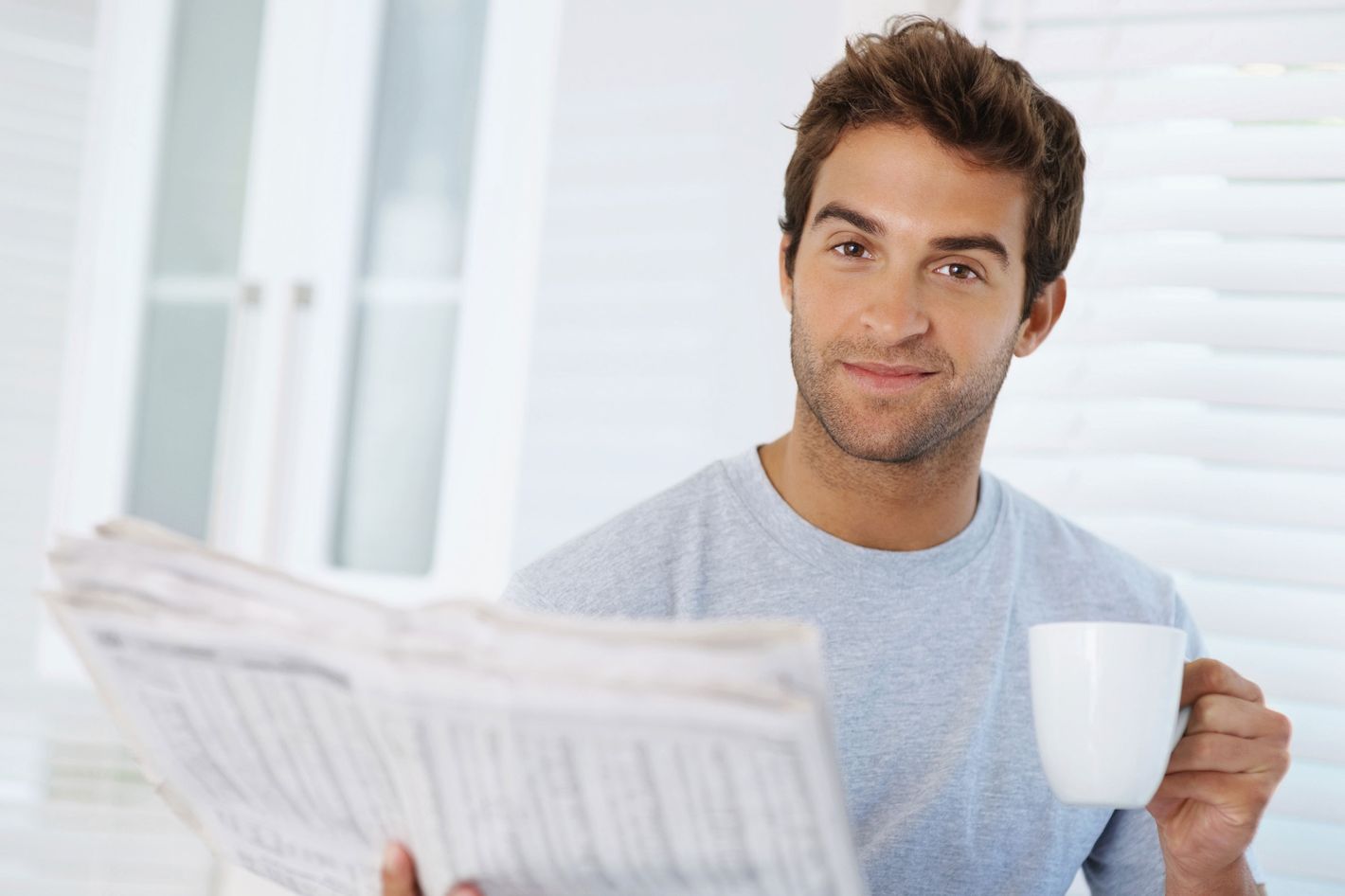 Very pleased. Happy man with Coffee. Man with Tea. Happy man with paper. Man drinking Coffee Glasses.