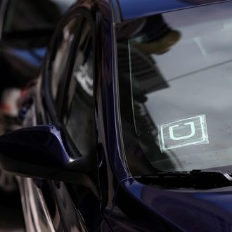 A sticker with the Uber logo is displayed in the window of a car on June 12, 2014 in San Francisco, California. The California Public Utilities Commission is cracking down on ride sharing companies like Lyft, Uber and Sidecar by issuing a warning that they could lose their ability to operate within the state if they are caught dropping off or picking up passengers at airports in California.