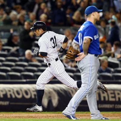 Ichiro Suzuki #31 of the New York Yankees runs the bases after his third inning home run past Brett Lawrie #13 of the Toronto Blue Jays at Yankee Stadium on September 20, 2012 in the Bronx borough of New York City