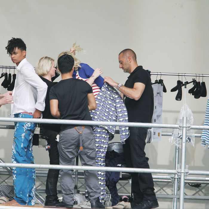 The scene backstage at the John Galliano men's show in Paris today.