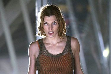 Milla wised up a bit for Resident Evil 2, but the skin-baring asymmetrical look was still in full force, except now it appeared as a grungy fishnet tunic layered over an orange tank top and black pants missing a thigh. Interesting!