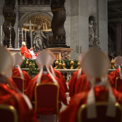Dean of the College of Cardinals Angelo Sodano (L) leads a mass at the St Peter's basilica on March 12, 2013 at the Vatican. Cardinals moved into the Vatican today as the suspense mounted ahead of a secret papal election with no clear frontrunner to steer the Catholic world through troubled waters after Benedict XVI's historic resignation.The 115 cardinal electors who pick the next leader of 1.2 billion Catholics in a conclave in the Sistine Chapel will live inside the Vatican walls completely cut off from the outside world until they have made their choice.