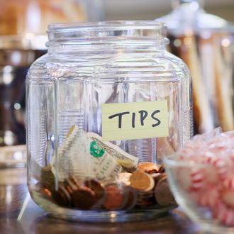 Tip Jar on Store Counter --- Image by ? Rick Gayle Studio/Corbis