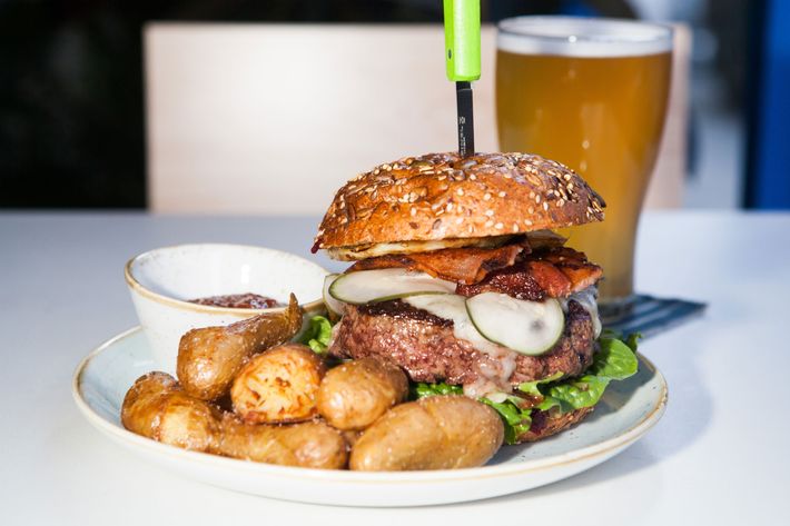 The Two Hands beef burger, with crispy potatoes and housemade ketchup (avocado and bacon are optional).