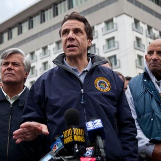 New York Governor Andrew Cuomo (C) speaks to members of the media about recovering efforts after Hurricane Sandy, on October 31, 2012 in Long Beach, New York. Businesses across the eastern seaboard are attempting to return to normal operations as clean-up from Hurricane Sandy continues. 