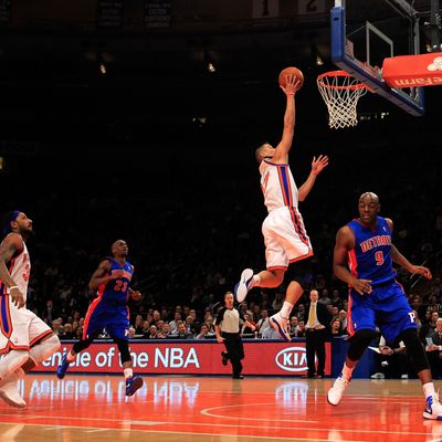 NEW YORK, NY - JANUARY 31: Jeremy Lin #17 of the New York Knicks lays the ball up over Damien Wilkins #9 of the Detroit Pistons at Madison Square Garden on January 31, 2012 in New York City. NOTE TO USER: User expressly acknowledges and agrees that, by downloading and or using this photograph, User is consenting to the terms and conditions of the Getty Images License Agreement. (Photo by Chris Trotman/Getty Images)