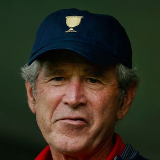 President George W. Bush watches the action alongside PGA Tour Commissioner Tim Finchem (L) during the Day One Four-Ball Matches at the Muirfield Village Golf Club on October 3, 2013 in Dublin, Ohio. 
