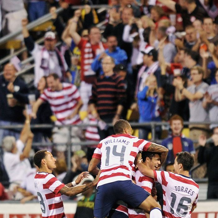 Team USA players swarm all over teammate Herculez Gomez #9 after Gomez scored in the 55th minute on a free kick against Jamaica on September 11, 2012 at Crew Stadium in Columbus, Ohio. USA defeated Jamaica 1-0.
