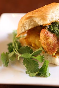 Potato fritters with chutney and spices, on a bun