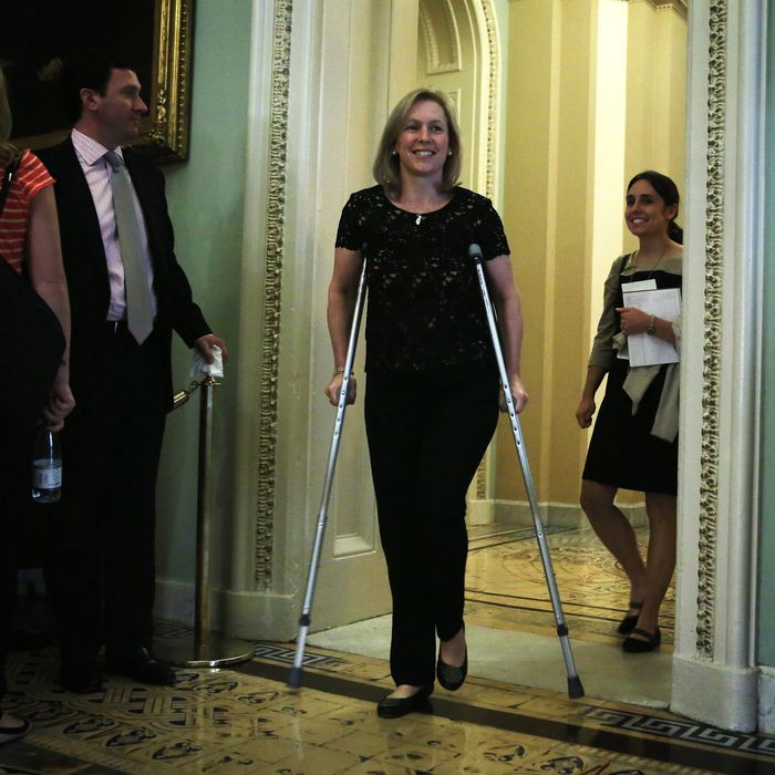 U.S. Sen. Kirsten Gillibrand (D-NY) walks on crutches as she arrives at the Senate Democratic Policy luncheon at the U.S. Capitol October 15, 2013 on Capitol Hill in Washington, DC. The U.S. government shutdown is entering its 15th day as the U.S. Senate and House of Representatives remain gridlocked on funding the federal government.