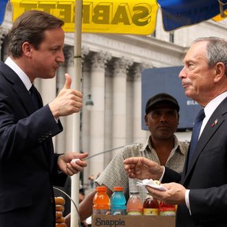 NEW YORK - JULY 21: British Prime Minister David Cameron (L) gives a thumbs up after eating a hot dog with New York City Mayor Michael Bloomberg outside Penn Station on July 21, 2010 in New York City. Cameron will conclude his two-day visit to the U.S. by conducting meetings with Bloomberg and UN Sec. General Ban Ki-moon in New York. (Photo by Oli Scarff/Getty Images) *** Local Caption *** David Cameron;Michael Bloomberg