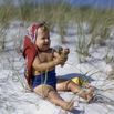 Baby Sitting On Beach