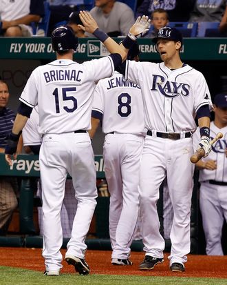 ST. PETERSBURG, FL - SEPTEMBER 26: Infielder Ben Zobrist #18 of the Tampa Bay Rays congratulates Reid Brignac #15 after he scores against the New York Yankees during the game at Tropicana Field on September 26, 2011 in St. Petersburg, Florida. (Photo by J. Meric/Getty Images)